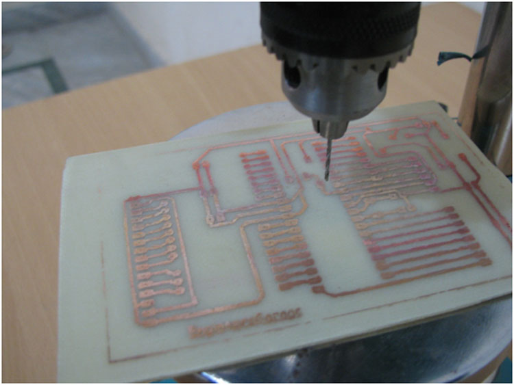 Image showing holes drilled in PCB for placing components Image showing holes drilled in PCB for placing components